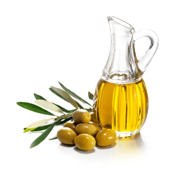 a glass jug with a glass handle next to olives