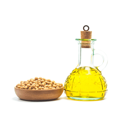 a glass bottle with a cork stopper next to a bowl of soybeans