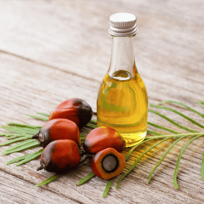 a bottle of oil next to fruit